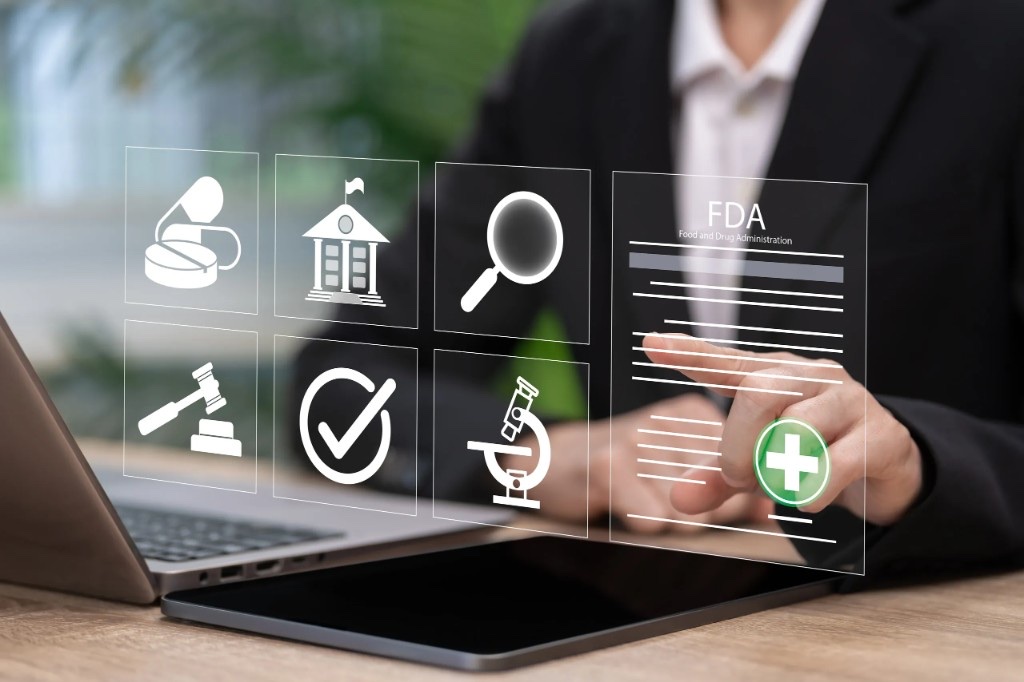 Professional reviewing FDA certification documents on a digital display